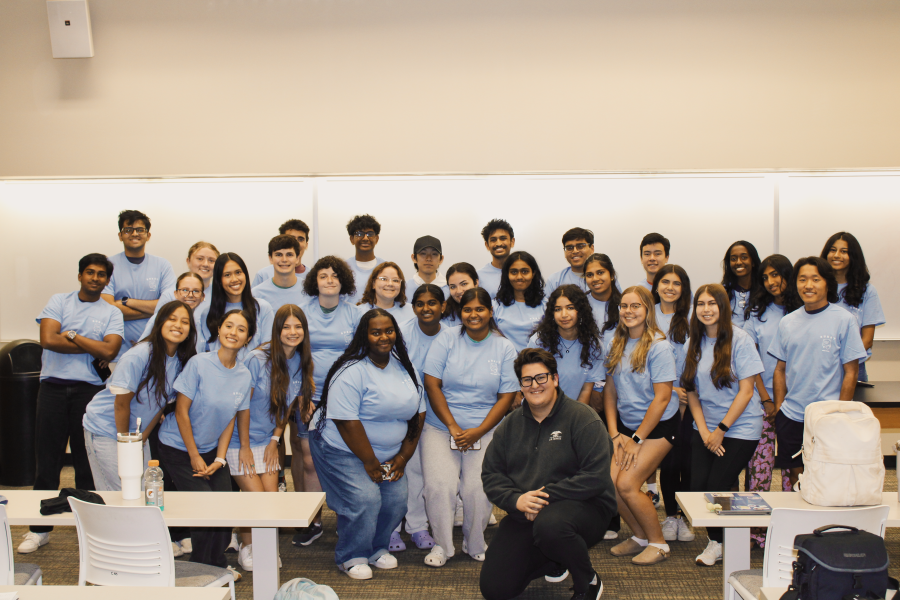 Group of BURST students wearing matching light blue shirts.